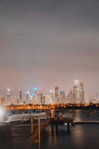 a city skyline with boats and a dock 