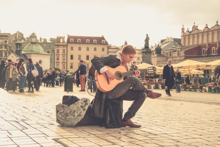 Street performer playing guitar at Circular Quay, showcasing vibrant street performances at Circular Quay
