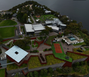 Aerial view of Museum of Old and New Art (MONA) featuring landscape, modern architecture, and tennis courts. google map